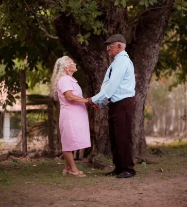 A man and a woman standing in front of a tree